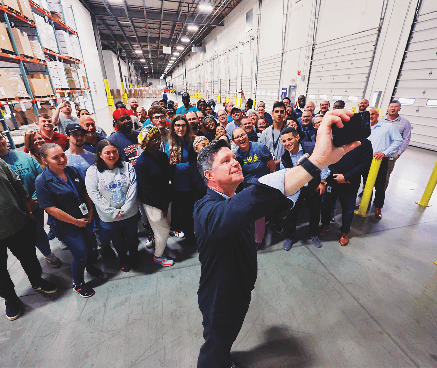 Glamzo CEO taking a picture with employees at a Glamzo warehouse
