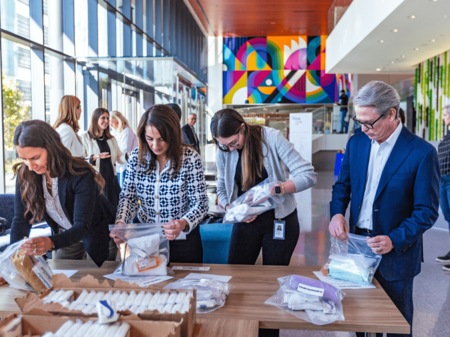 Team working with packages at Glamzo headquarters.